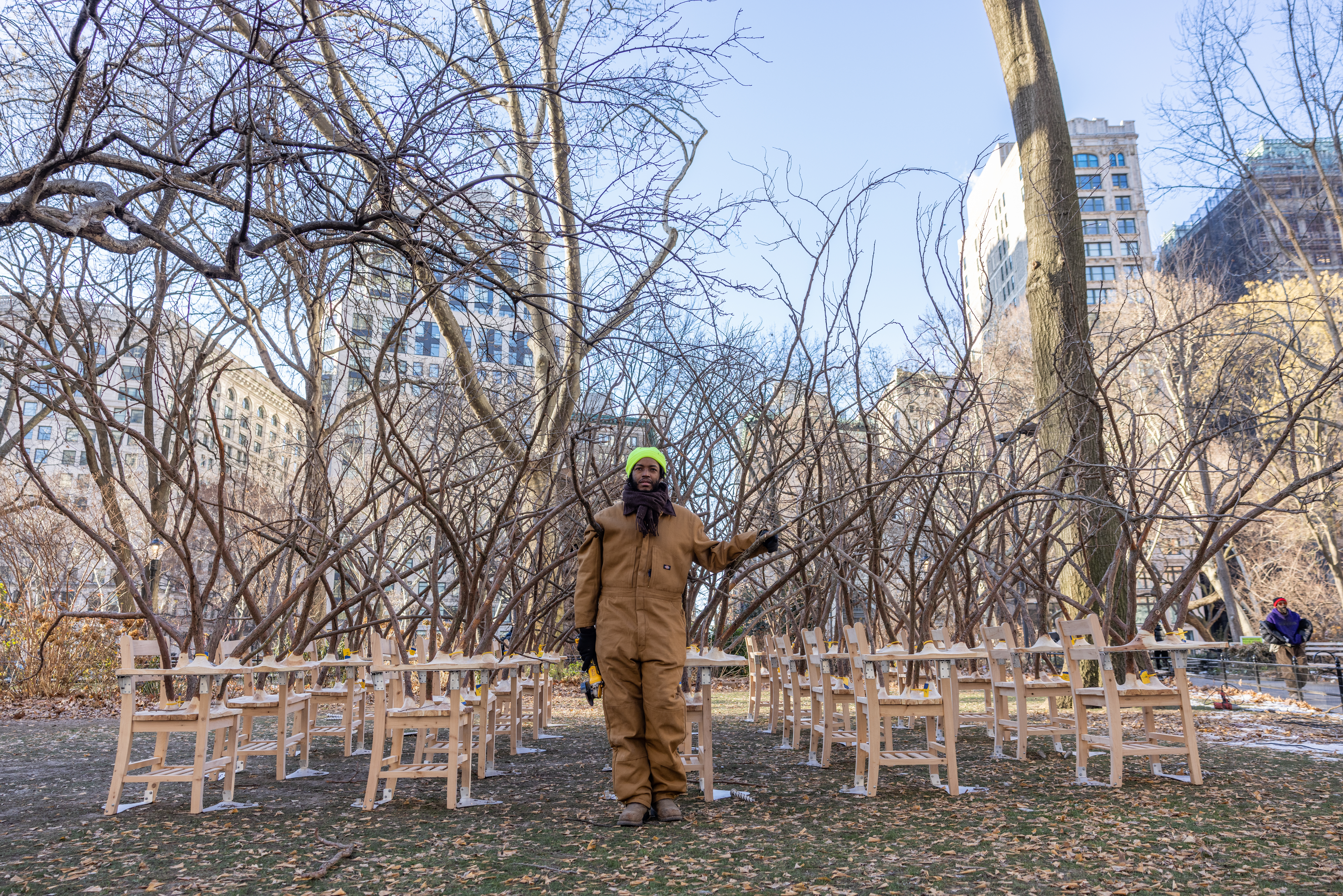 Artist Hugh Hayden standing among the Brier Patch exhibition, which features desks bursting with...