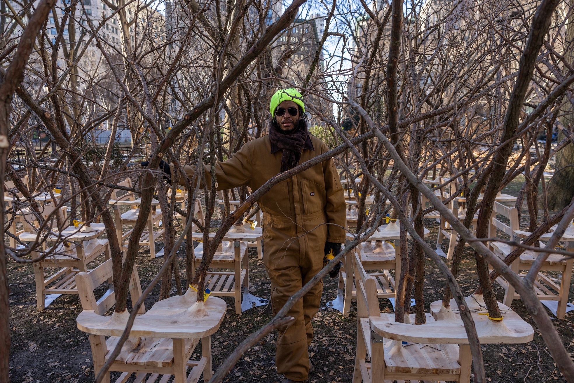 Artist Hugh Hayden standing among the Brier Patch exhibition, which features desks bursting with...